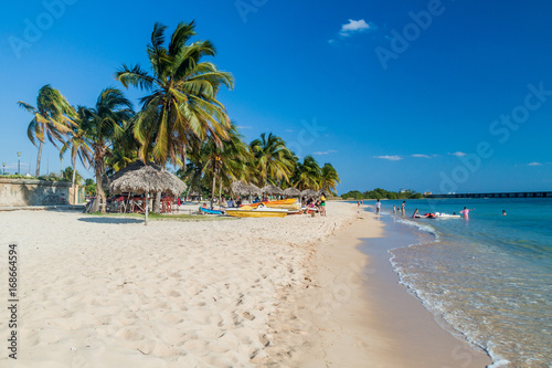 PLAYA GIRON, CUBA - FEB 14, 2016: Tourists at the beach Playa Giron, Cuba. This beach is famous for its role during the Bay of Pigs invasion.