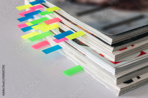 many colorful bookmarks in a magazine with the shallow depth of scene