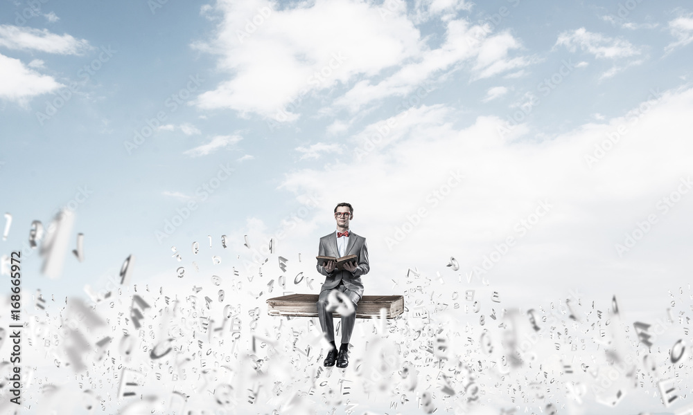Young businessman or student studying the science and symbols fl Young businessman or student studying the science and symbols fl