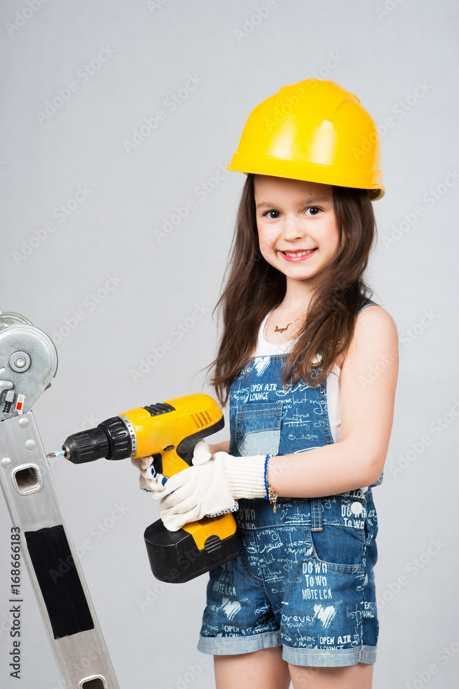 Little beautiful girl playing construction tools. Little beautiful girl playing construction tools.