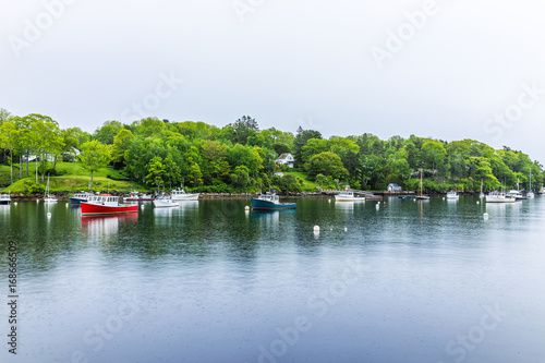Картината върху платно Empty marina harbor in small village in Rockport, Maine during rain with boats