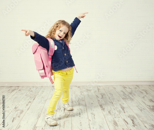 Little girl with schoolbag photo