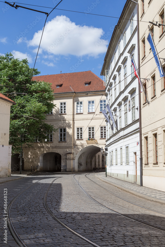 Tramway tracks at empty Letenska Street and old buildings at the Mala Strana (Lesser Town) district in Prague, Czech Republic.