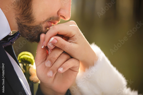 Wedding kiss. Groom kisses bride's hand. Weddng love