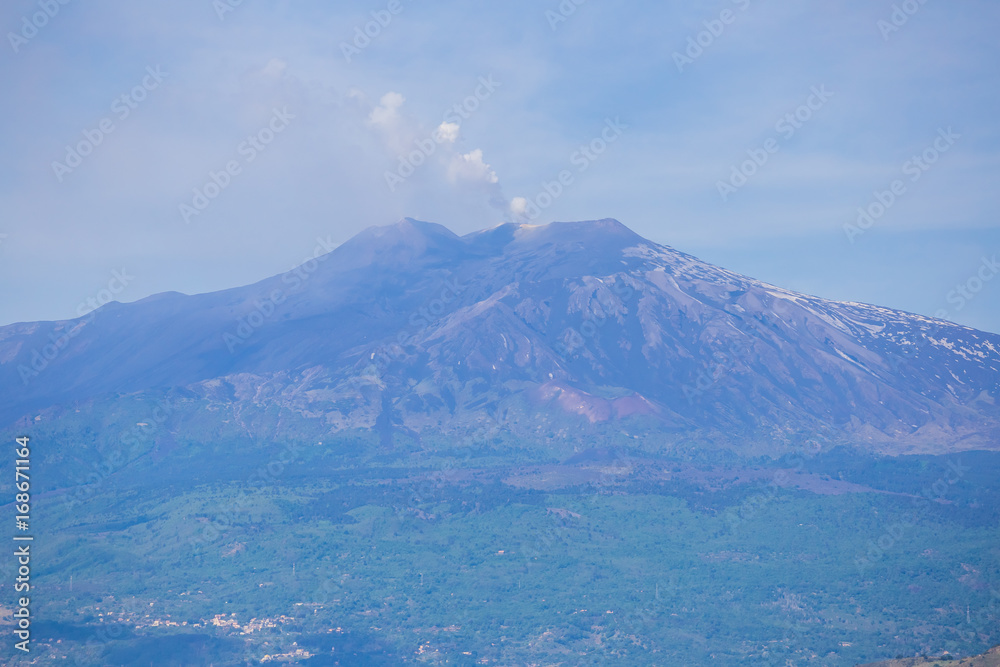 Panoramic view of Etna volcano and beautiful town of Taormina in the foreground, Sicily island, Italy