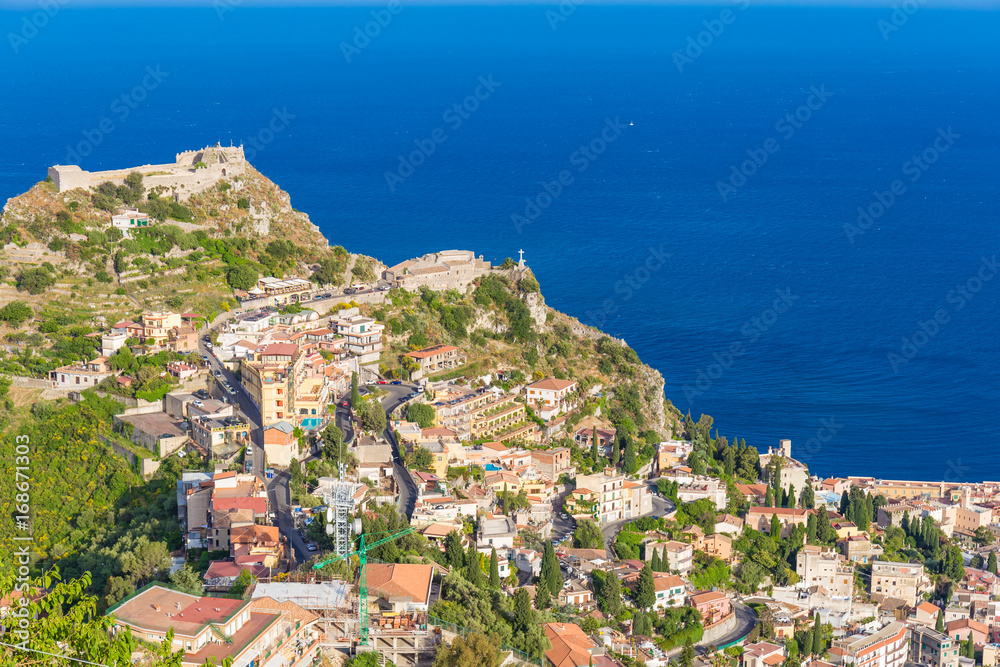 Panoramic view of small Village of Castelmola, overlooking town of Taormina with sea background, Sicily island, Italy