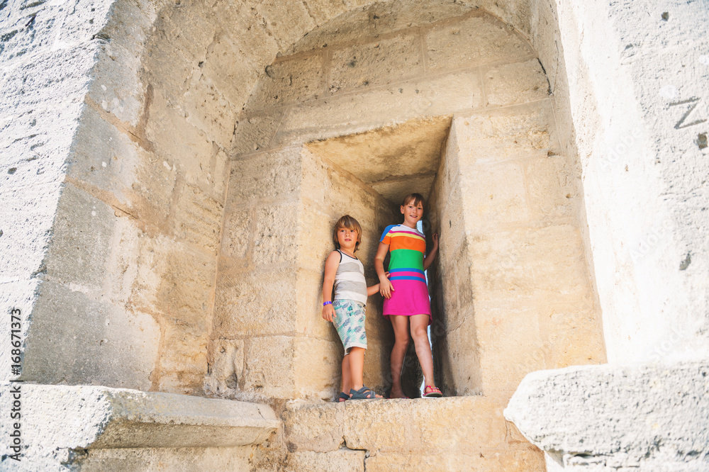 Kids playing in fortress during summer vacation in Aigues-Mortes, Camargue, France