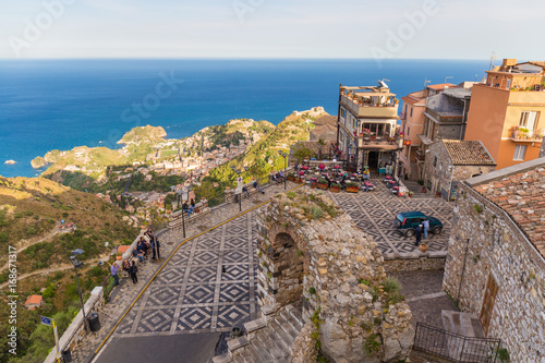 Panoramic view of small Village of Castelmola, overlooking town of Taormina with sea background, Sicily island, Italy photo