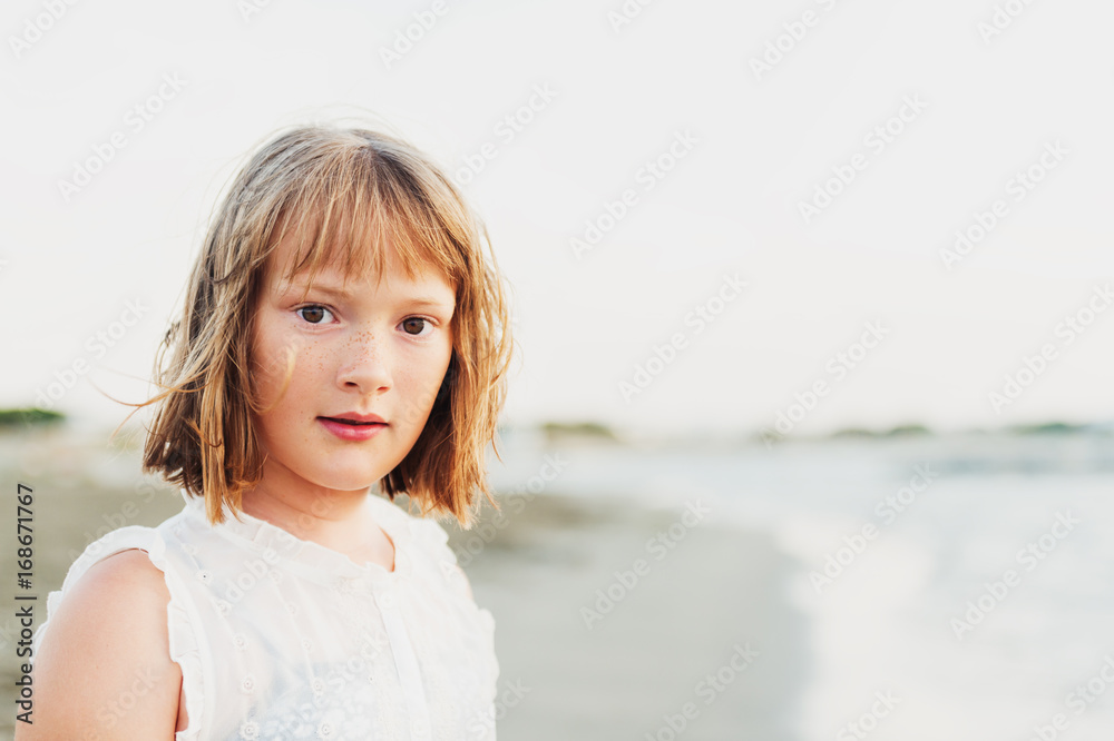 Close up portrait of sweet little girl with short bob haircut resting by the sea Close up portrait of sweet little girl with short bob haircut resting by the sea