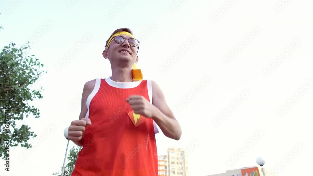Funny thin guy in sports clothes jogging on the bridge in the morning. Funny thin guy in sports clothes jogging on the bridge in the morning.