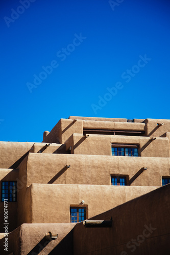 Adobe style building in Santa Fe, New Mexico against a clear blue sky