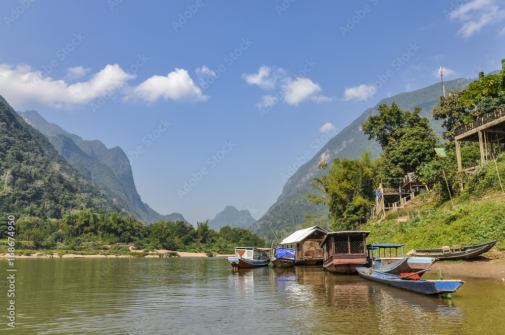 Boats on the shore in Muang Ngoi, Laos