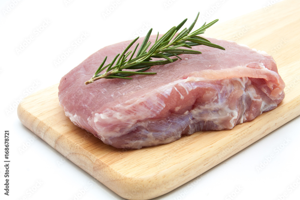 pieces of raw pork steak with spices and herbs rosemary