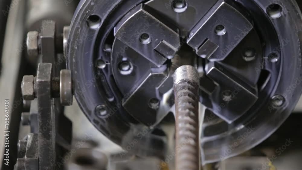 Steel Bar Being Cut In Machine Going In Circles With Water - Close Up Steel Bar Being Cut In Machine Going In Circles With Water - Close Up