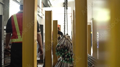 Two Factory Worker Helping Crane To Carry A Bundle Of Steel Bars - Slider - Right To Left 