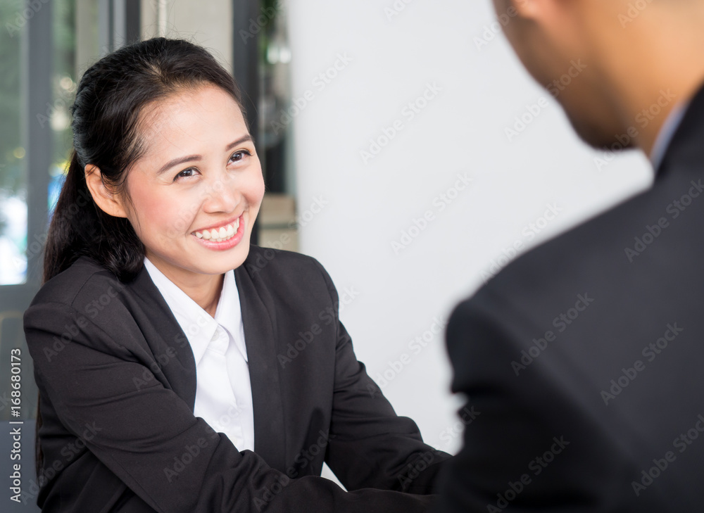 Young beautiful asian businesswoman in modern office, discussing during interview with manager in meeting room Young beautiful asian businesswoman in modern office, discussing during interview with manager in meeting room
