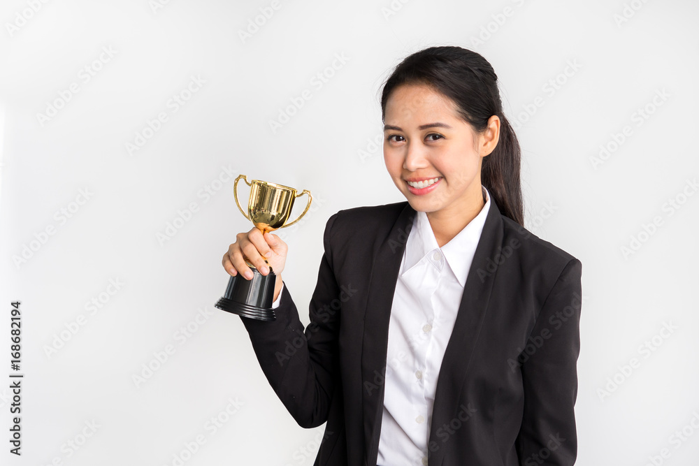 Young asian businesswoman in formal suit holding golden trophy on white background, winner and successful/achievement concept Young asian businesswoman in formal suit holding golden trophy on white background, winner and successful/achievement concept