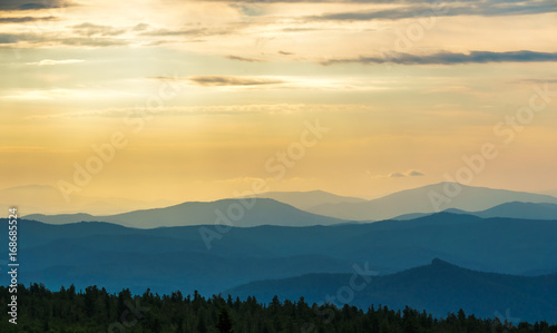 Sun rays at dawn over the mountain range.