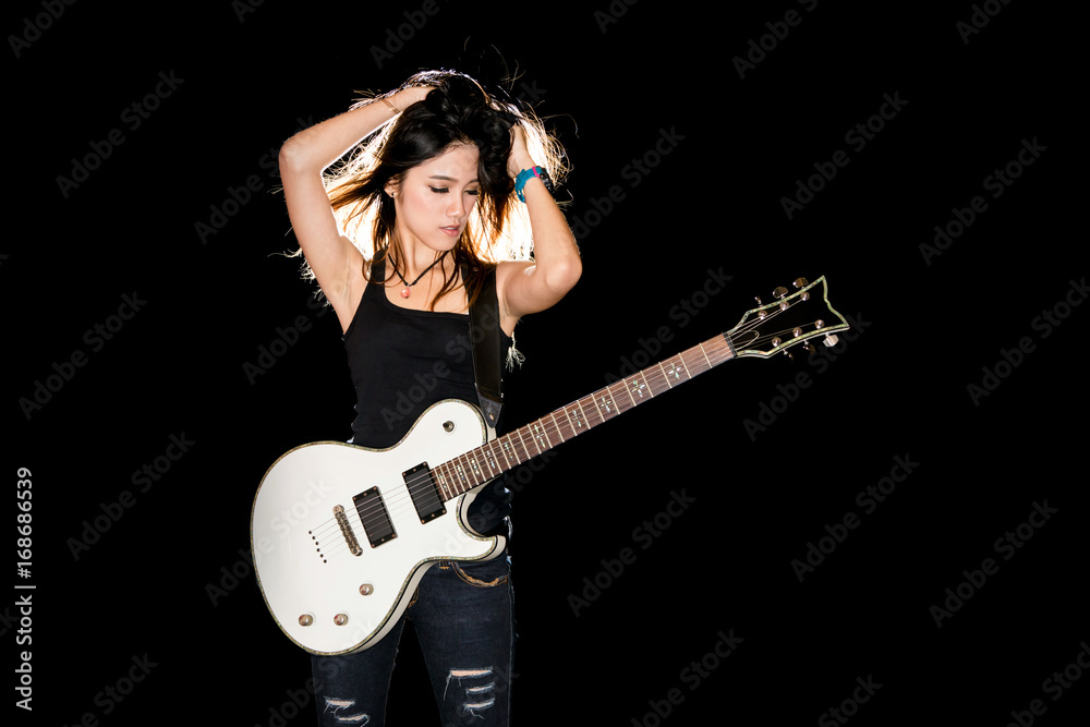 Obraz premium Young and beautiful rock girl playing the electric guitar