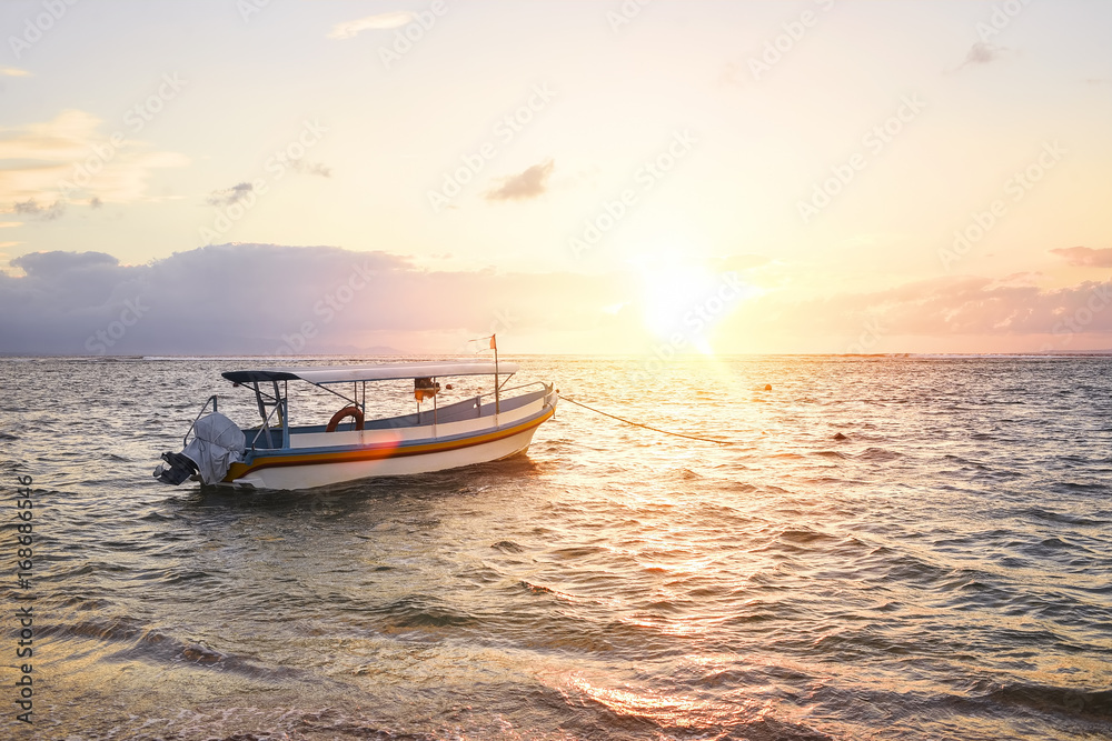 Stunning beautiful sunlight beach with fishing boats on a beach. Sanur Beach, Bali, Indonesia.