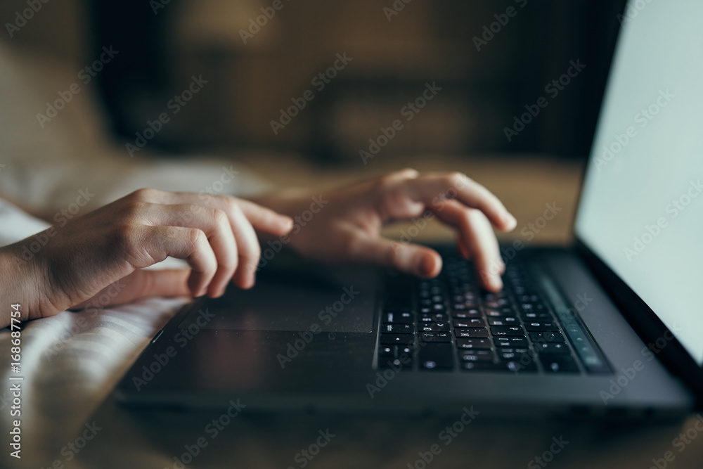 Woman typing on laptop keyboard, hands, work