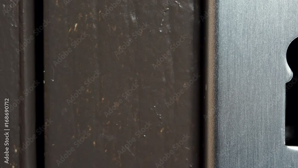 Closeup of key hole in old wooden door without key. Dolly sliding shot 4K ProRes HQ codec Closeup of key hole in old wooden door without key. Dolly sliding shot 4K ProRes HQ codec