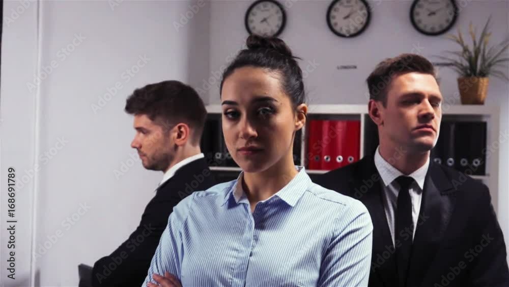 Cool Epic shot of three 3 confident collegues attractive handsome business managers businessman and businesswoman office inside turn their head to camera. Slow motion. Cool Epic shot of three 3 confident collegues attractive handsome business managers businessman and businesswoman office inside turn their head to camera. Slow motion.