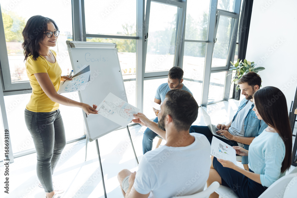 Cheerful positive woman giving schemes to her team Cheerful positive woman giving schemes to her team
