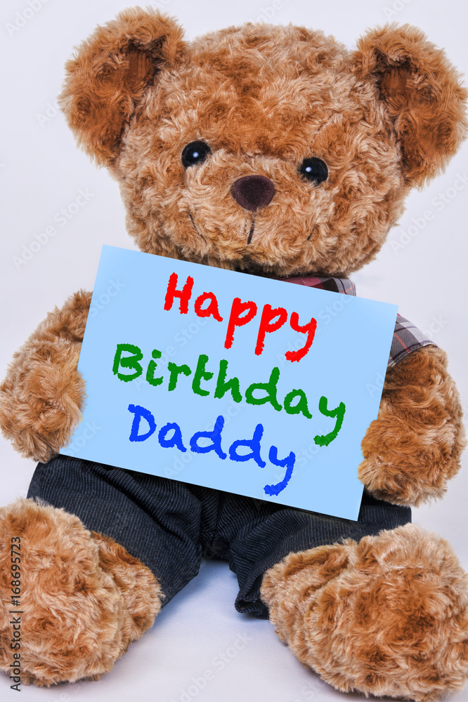 Teddy bear holding blue sign saying Happy Birthday Daddy Stock Adobe Stock