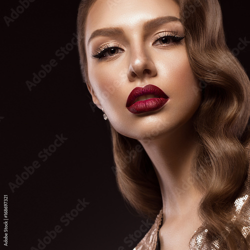 beautiful girl in Hollywood image with wave and classic makeup. Beauty face. Photo taken in the studio.