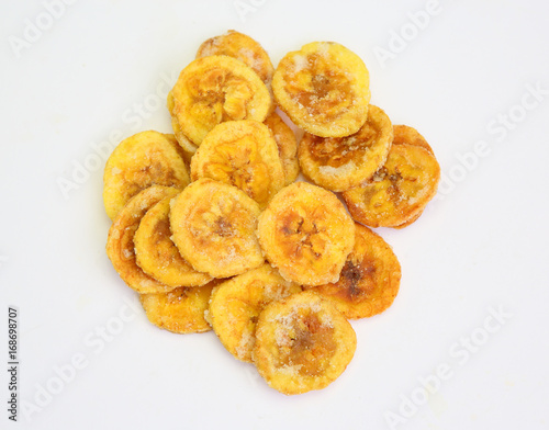 dried banana slices coated with sugar isolated on white background. © zilvergolf