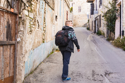 Young hipster man traveling backpacker outdoor. Travel concept. © satura_