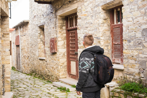 Man traveler with hat and backpack enjoying view