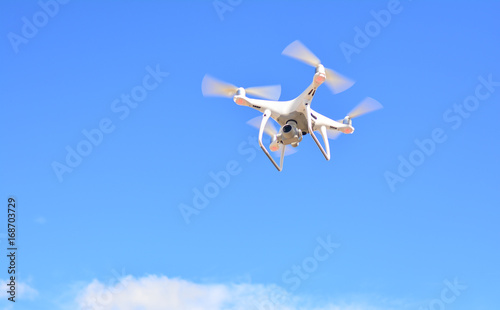 Drone camera flying for take a picture on blue sky background