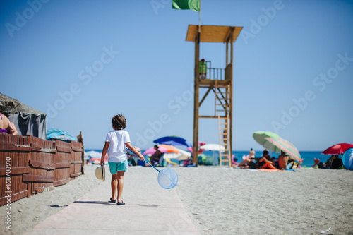niño jugando en la playa españa málaga costa del sol photo