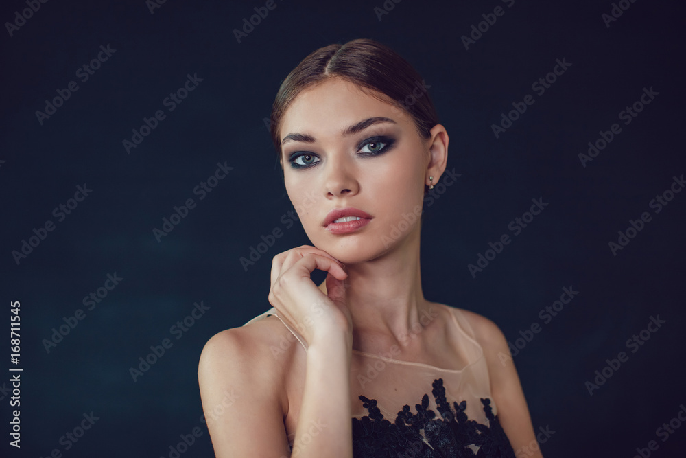 Attractive woman with make up on a dark background. Attractive woman with make up on a dark background.