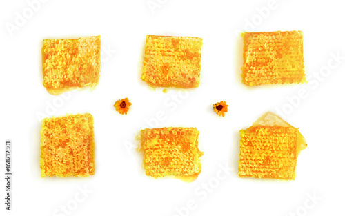 Honeycombs with honey and orange flowers on a white background. Top view, flat lay