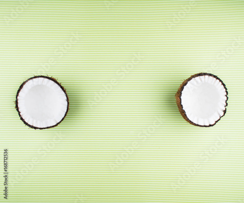 Fruits of coconuts on green background.