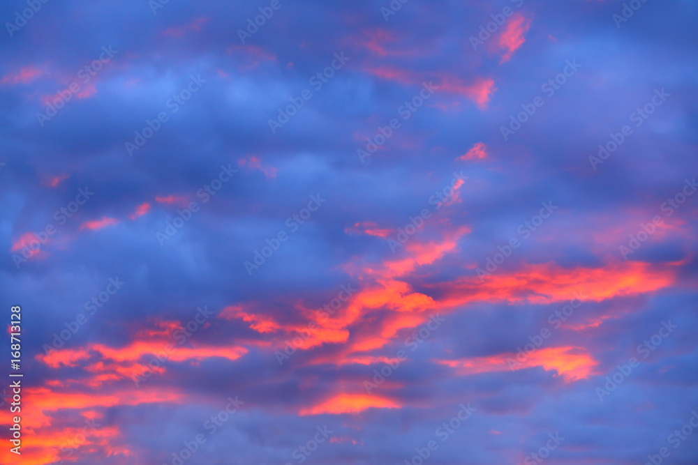 Beautiful orange cloudscape in the late evening with high saturation and using multiple exposure