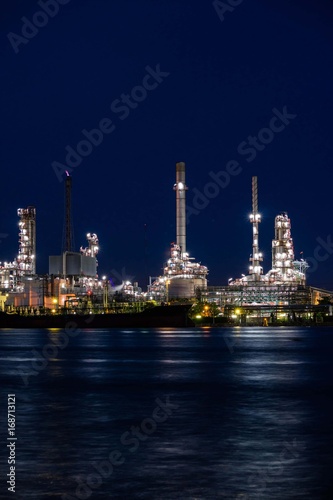 Oil refinery plant near river at twilight  Business and  Industry concept