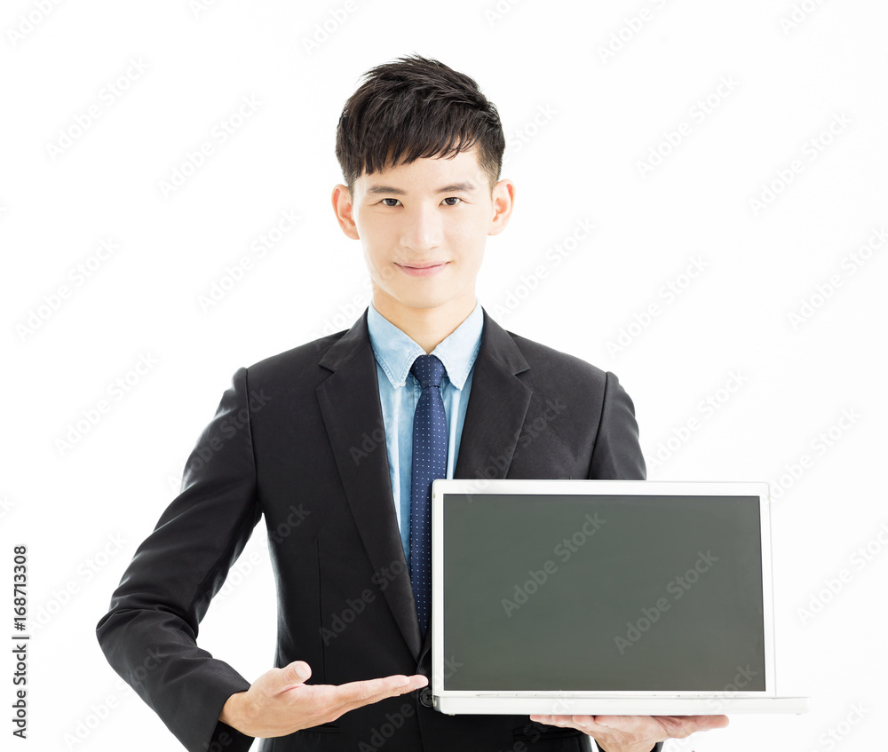 Happy young businessman holding laptop . Happy young businessman holding laptop .