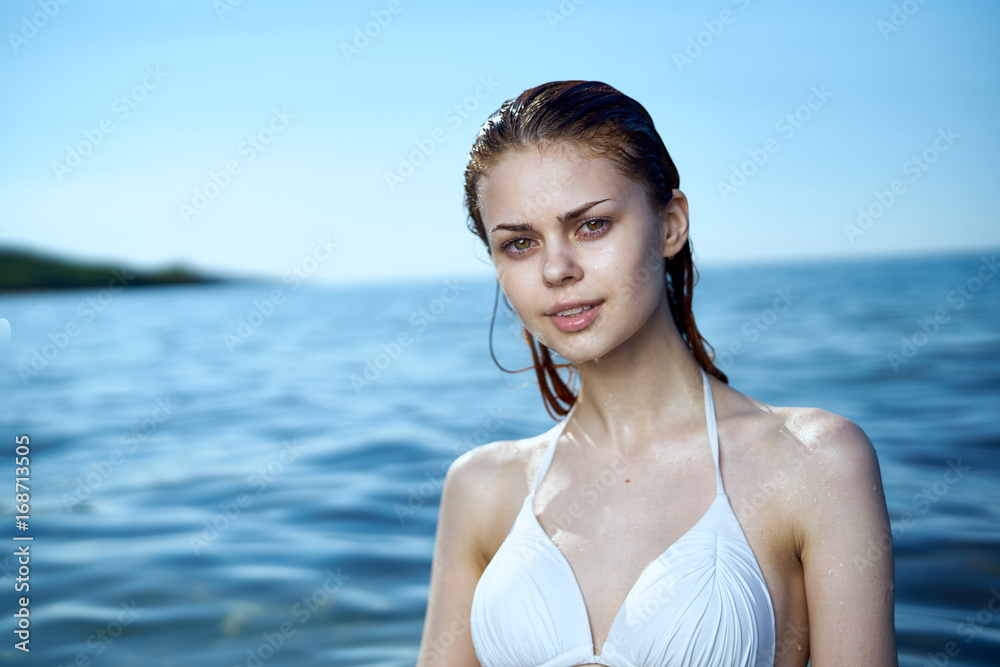 Beautiful young woman is resting on the sea, ocean, beach, water, vacation