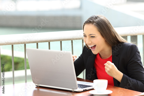 Free Download Excited executive reading notification in a laptop - GFXLoad