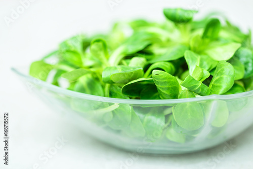 Fresh green salad with spinach In a glass bowl