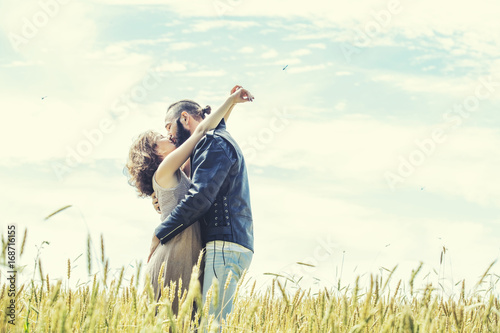 Beautiful couple man and woman in love in the field against the sky happy © kuzmichstudio