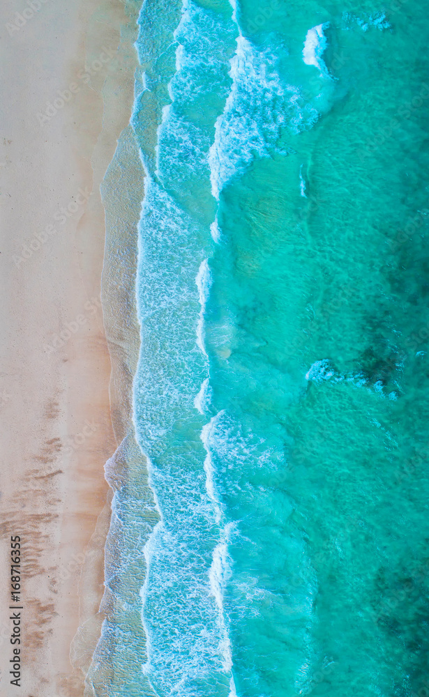 Fototapeta premium Sea aerial view,Top view,amazing nature background.The color of the water and beautifully bright.Azure beach with rocky mountains and clear water of Thailand ocean at sunny day.