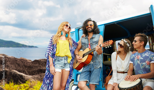 hippie friends playing music at minivan on island