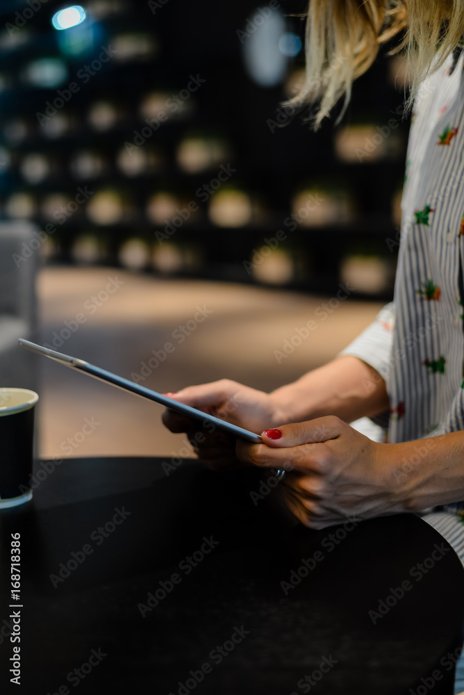 Business person using holding digital tablet mobile pc device over blurred background. Close up technology concept