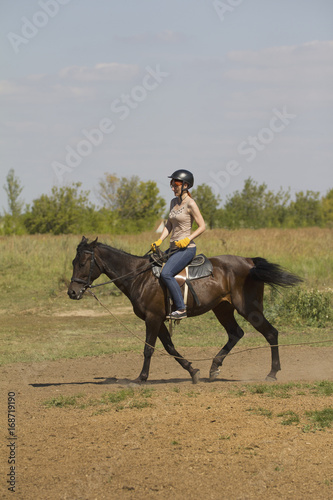 Women is horse riding - red hair girl in summer meadow © KONSTANTIN SHISHKIN