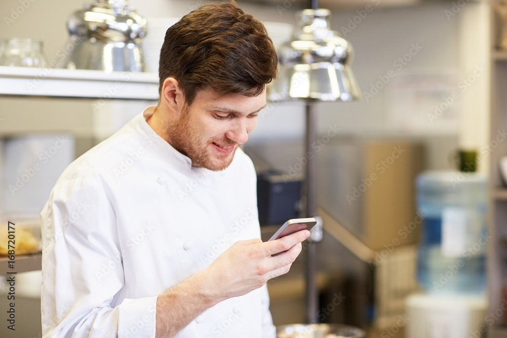 chef cook with smartphone at restaurant kitchen chef cook with smartphone at restaurant kitchen